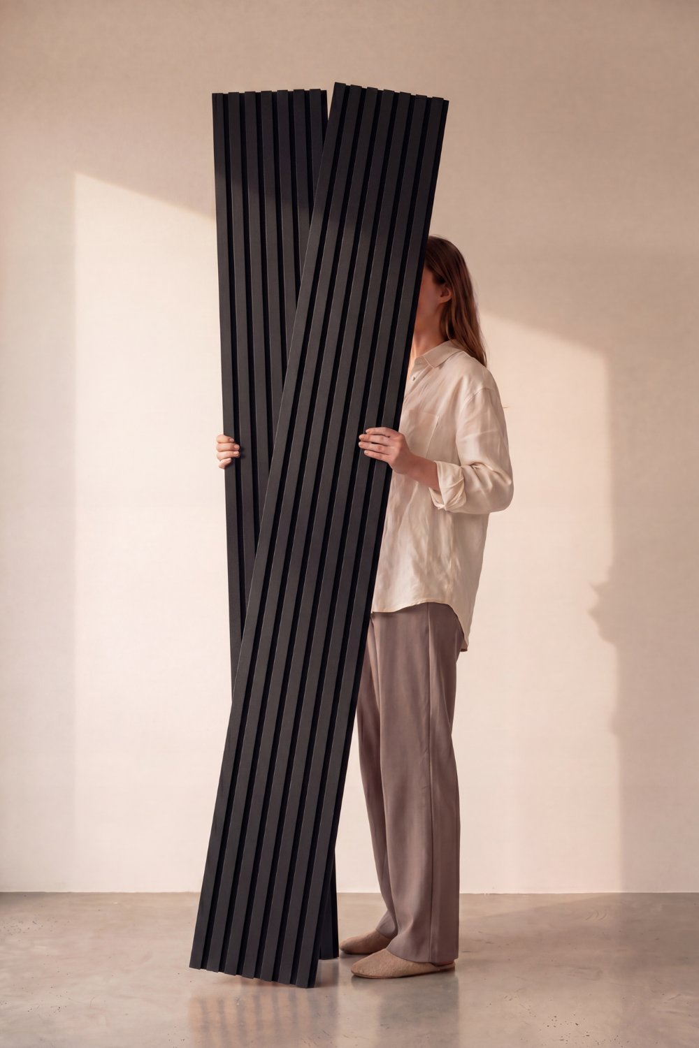 Black acoustic slat wall panel: studio panels held