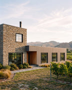 Grey composite exterior wall panels on a rural home exterior.