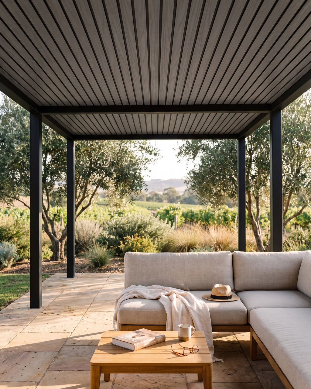 Grey exterior wall panels on a covered outdoor area with vineyard views.
