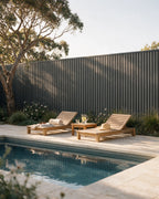 Grey composite wall panels used as a swimming pool fence.