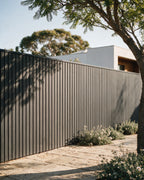 Grey composite wall panels forming a boundary fence.