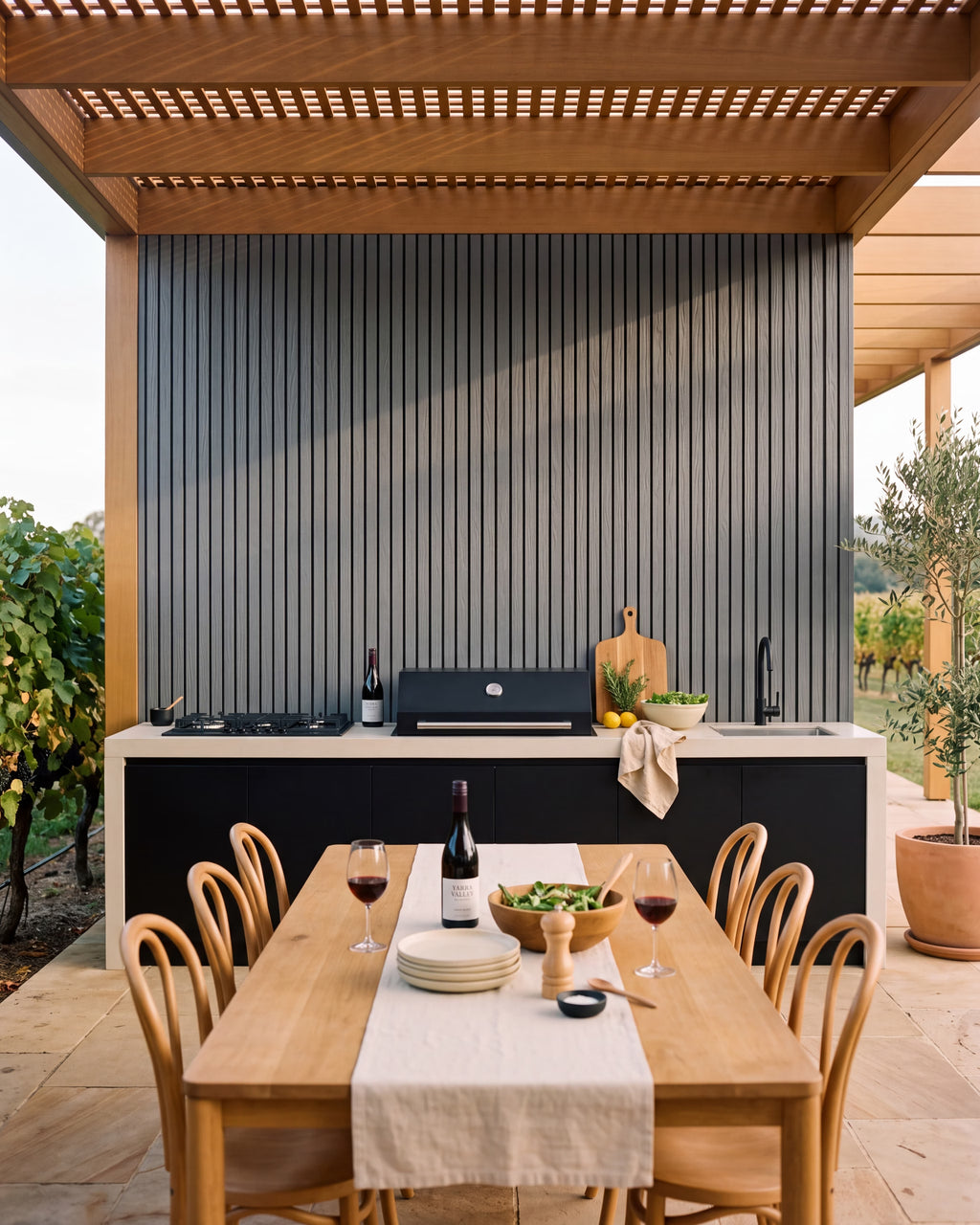 Grey wall panels behind a covered outdoor kitchen.