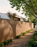 Oak composite wall panels forming a boundary fence.