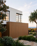 Oak composite wall panels on a coastal home exterior.