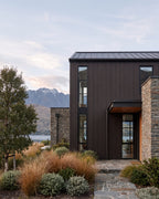 Walnut composite wood wall panels on a lakeside home exterior.