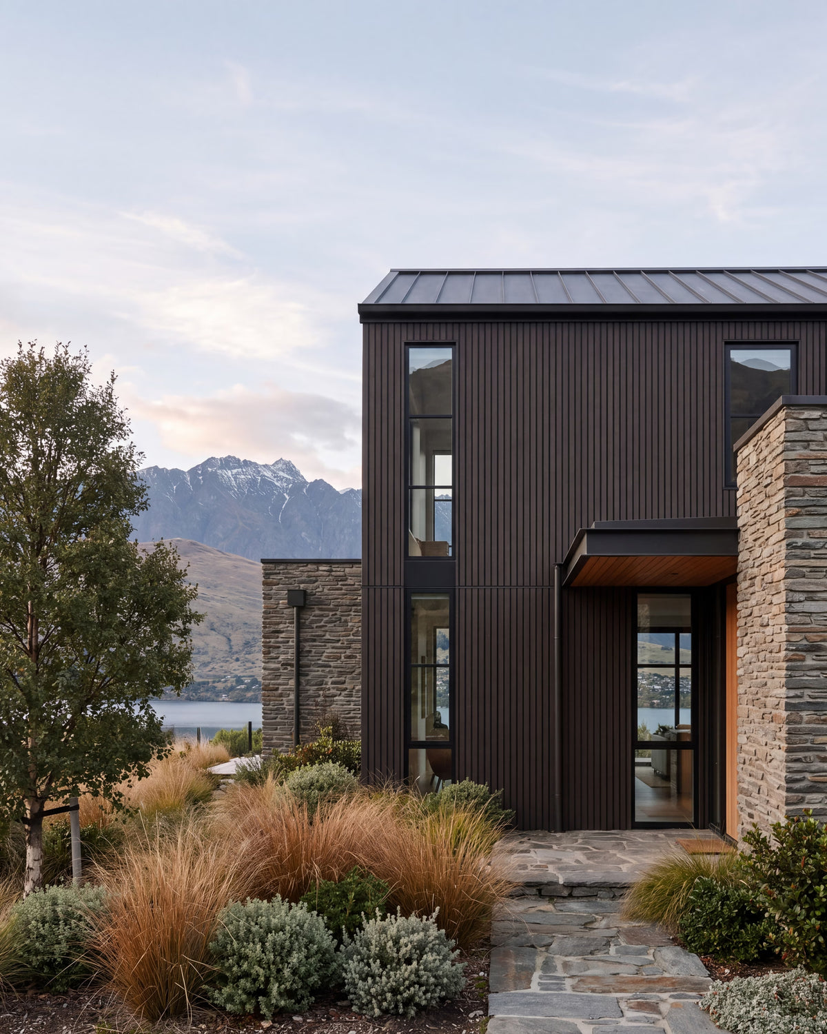 Walnut composite wood wall panels on a lakeside home exterior.